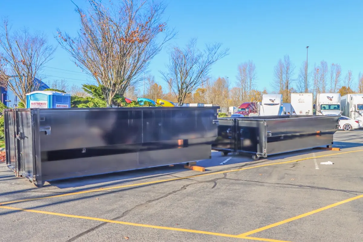 Professional dumpster rental service with roll-off container on residential driveway in Secaucus